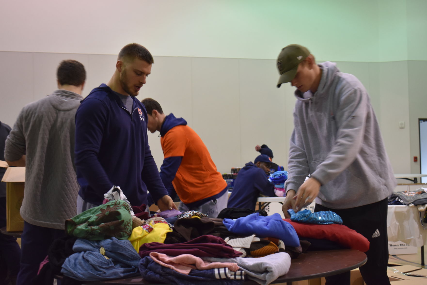 Auburn University football team volunteers at Greater Peace Missionary Baptist Church